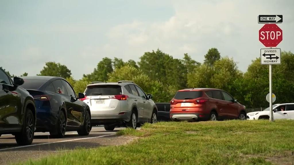 Drivers in Trinity Wait for Traffic Light at Busy Intersection